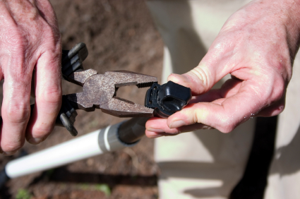 tightening a valve during a sprinkler repair in Wheat Ridge Colorado